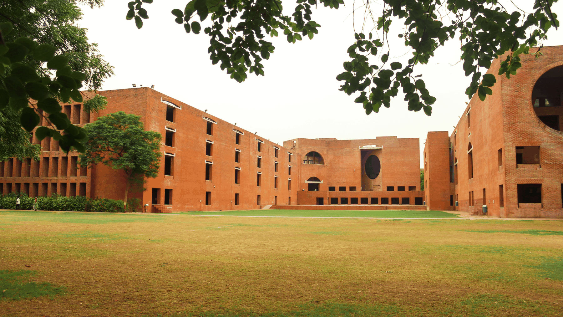 Wide view of Louis Kahn Plaza at IIM Ahmedabad with brick arches and circular openings